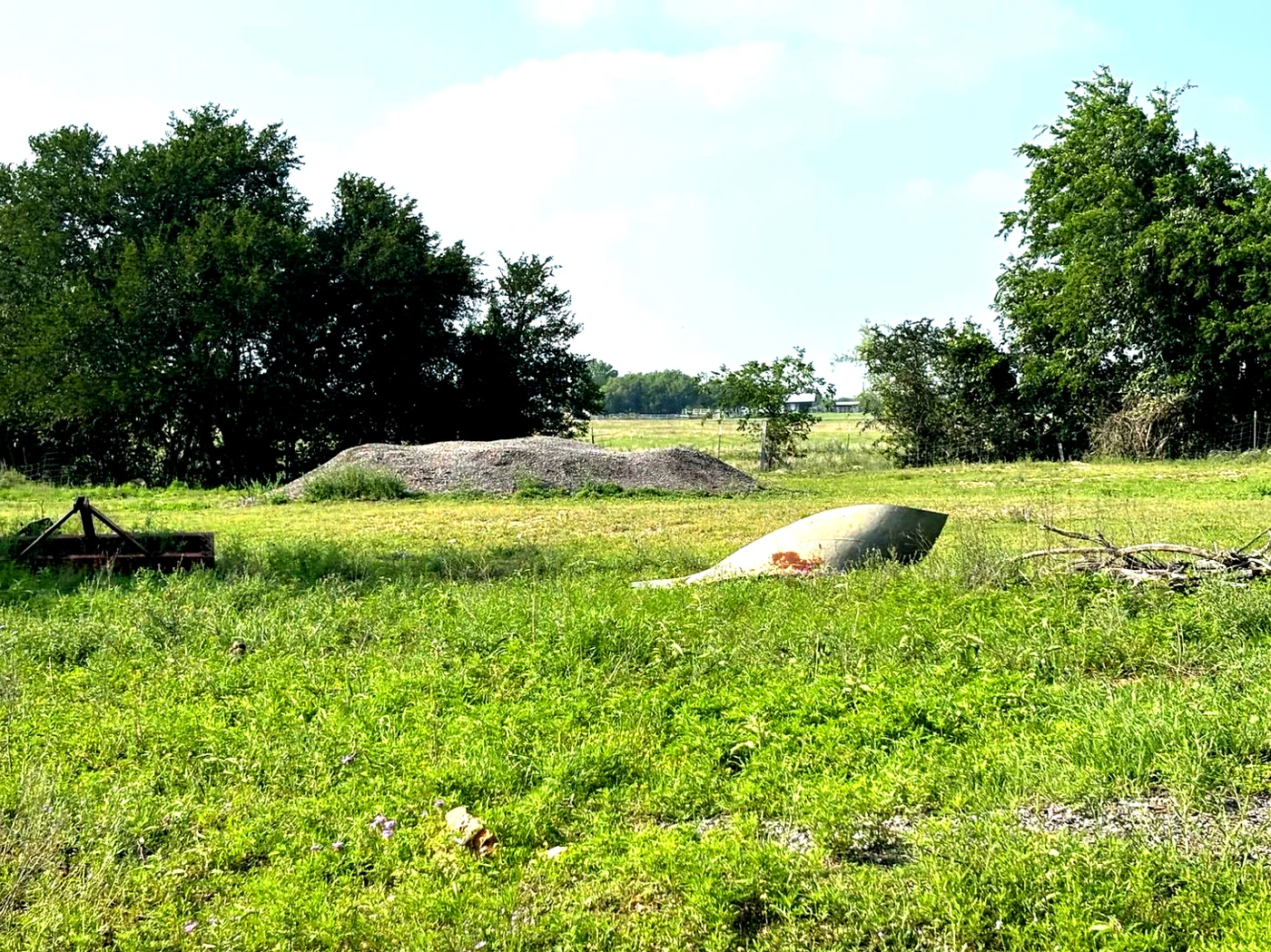 Two existing steel silo structures in green field at Still Haven, near Hutto Texas.